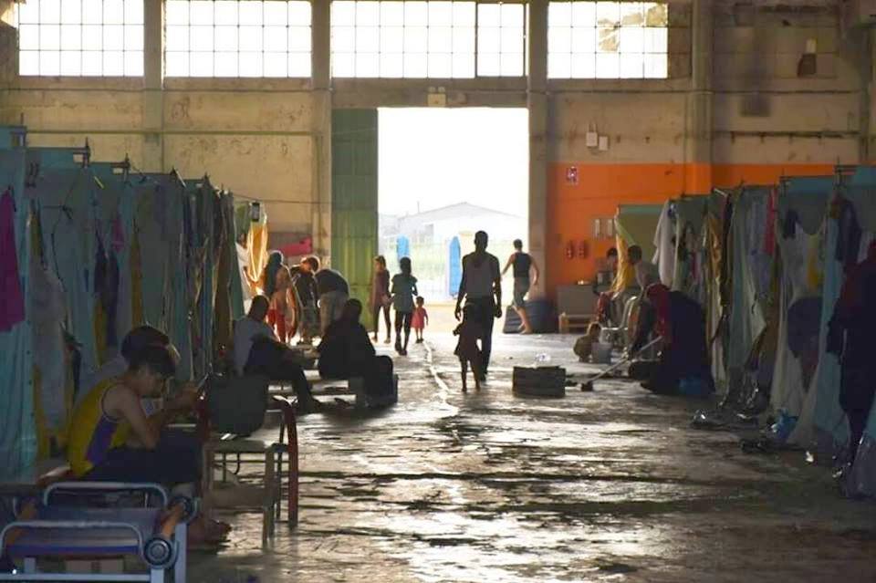 The refugee camp - rows of tents in a disused warehouse...