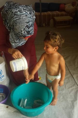 Qamar preparing to bathe Minas...